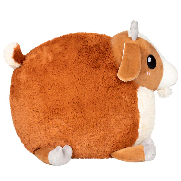 Baby Goat Squishable Plushie with round shape, brown and white fur, gray horns, and floppy ears.