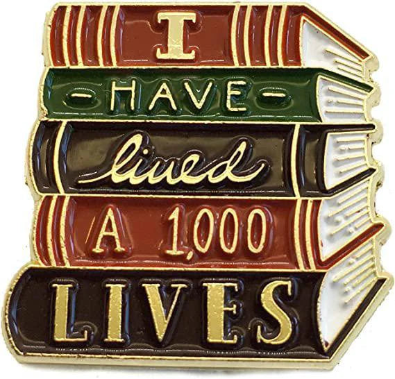 I Have Lived A Thousand Lives gold book enamel pin.