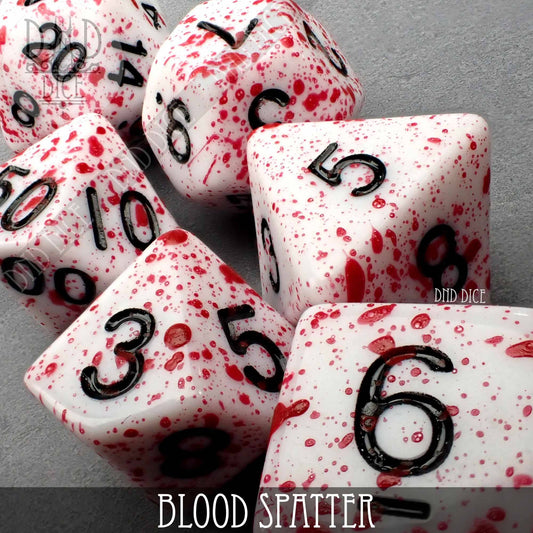White acrylic polyhedral dice with black numbers and red blood spatter on a gray background.