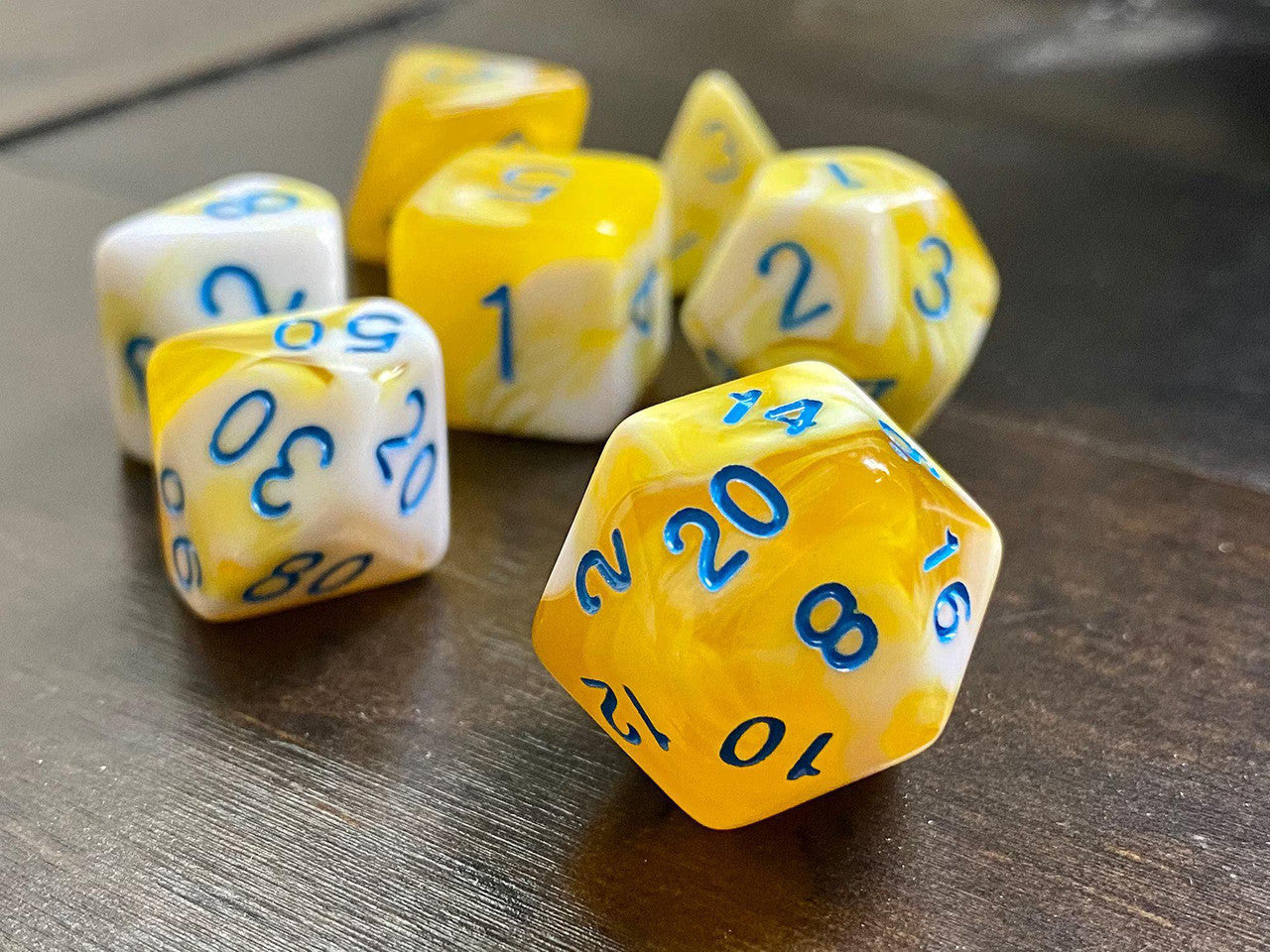 Frozen Butter RPG Dice Set with yellow and white polyhedral dice featuring blue numbers.