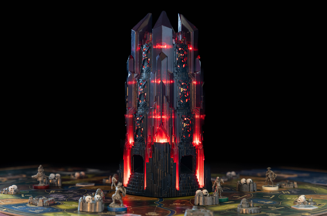 Return to Dark Tower cooperative board game featuring a glowing black tower with red lights at the center.