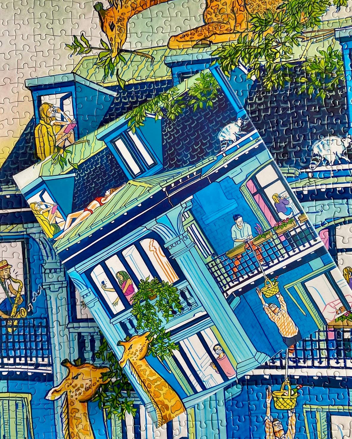 The City Culture 1000-piece puzzle for adults featuring Jules Monson’s blue house with giraffes in the windows.