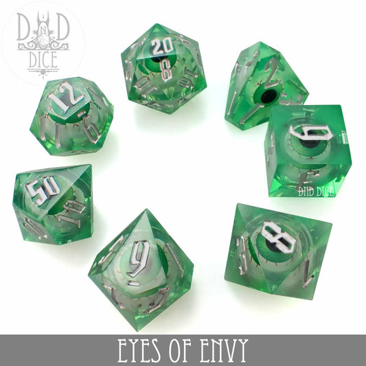 Eyes of Envy - Liquid Core dice set: 7 green resin dice with silver numbers and eye designs inside each.