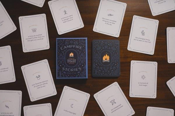 Campfire Stories Deck Prompts for Igniting Stories on a table with cards and simple illustrations nearby.