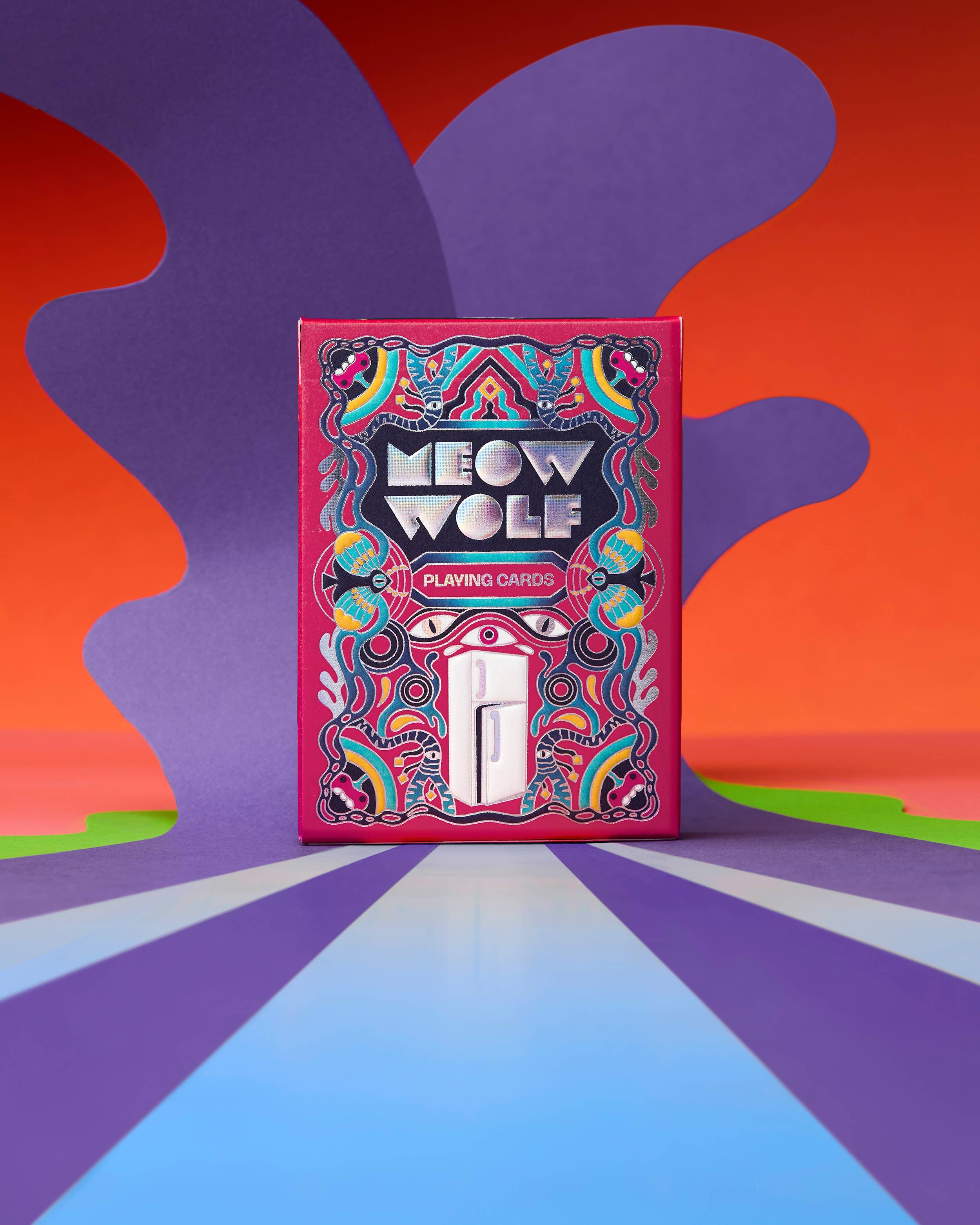 Meow Wolf playing cards in a pink holographic box featuring an illustration of a refrigerator.