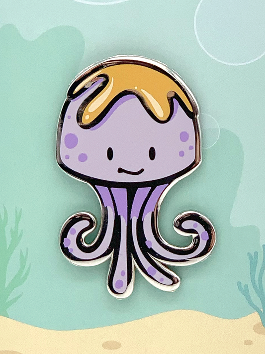Peanut Butter Jellyfish Enamel Pin showing a purple jellyfish with a yellow top and a smiling face.