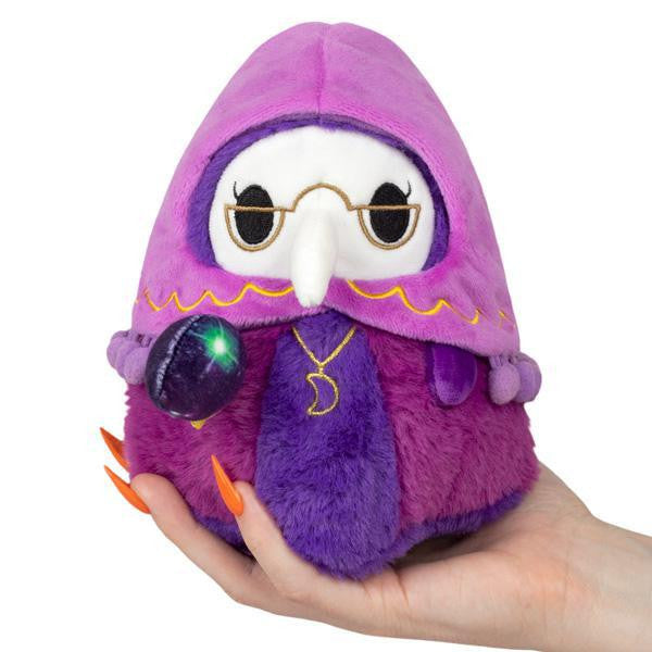 Alter Ego Plague Doctor Fortune Teller plush owl in purple, with glasses and a glowing green orb staff, held in a hand.