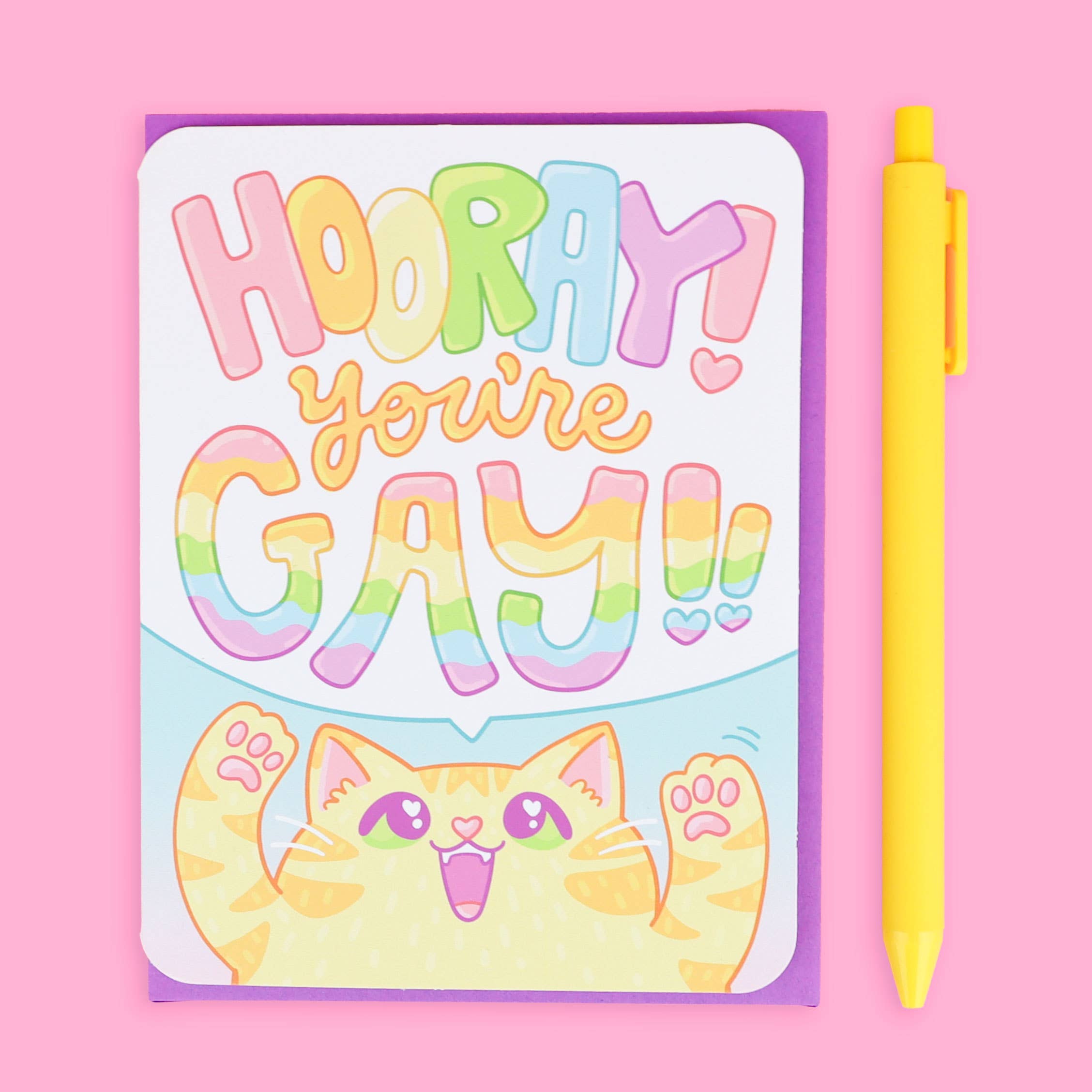 Hooray You’re Gay Kitten LGBTQ Queer greeting card with envelope, pink background, smiling cat, vibrant colors.