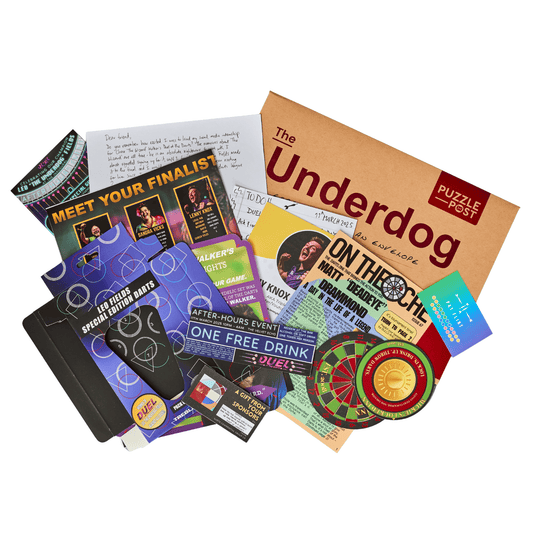 The Underdog Escape Room kit with cards, flyers, notebook, and envelope.