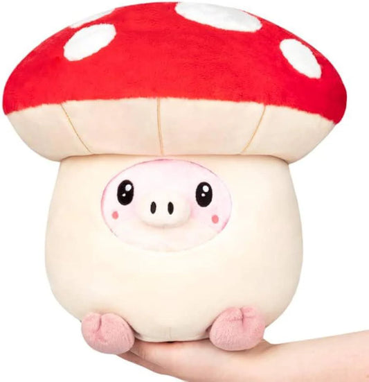 Undercover Pig in Mushroom Squishable plush, showing a pig partially inside a red-capped mushroom, held in a hand.