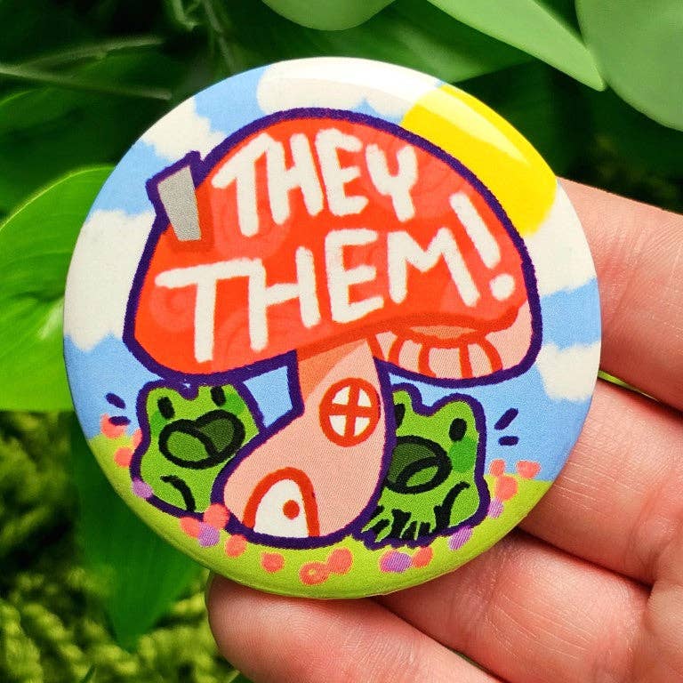 Laminated, waterproof pin featuring red mushroom, green frogs, and the text THEY THEM.