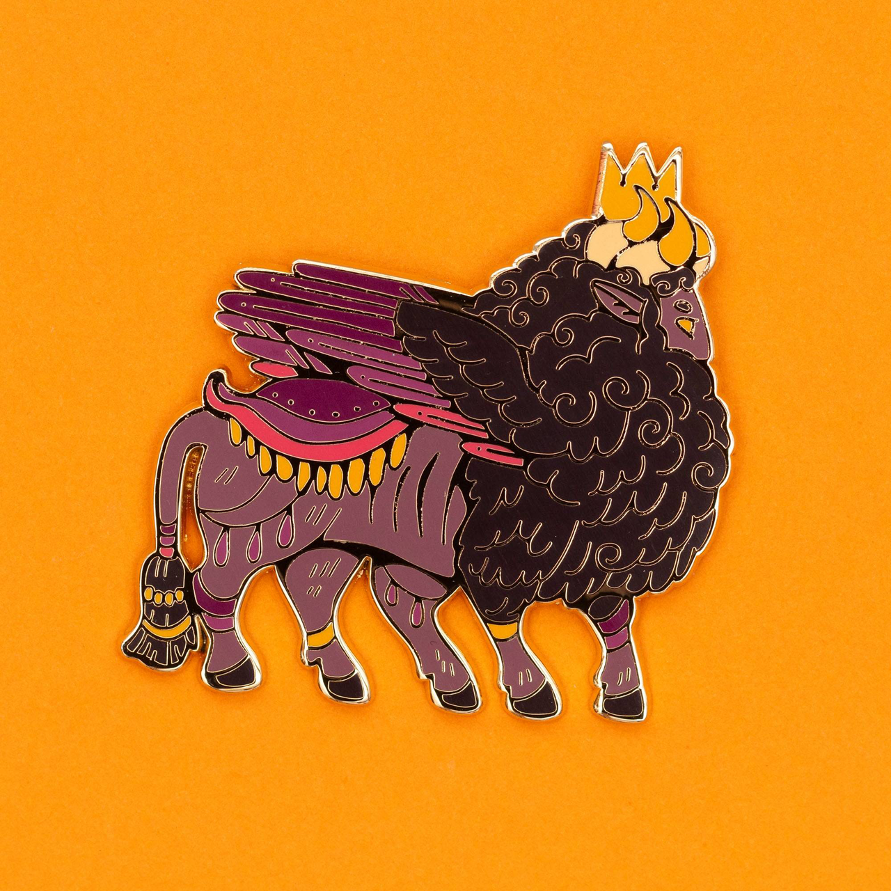Lamassu pin featuring a winged bull with curly mane and crown on an orange background.