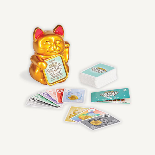 Golden lucky cat figurine and cards from the Lucky Cat Game collecting card game set.