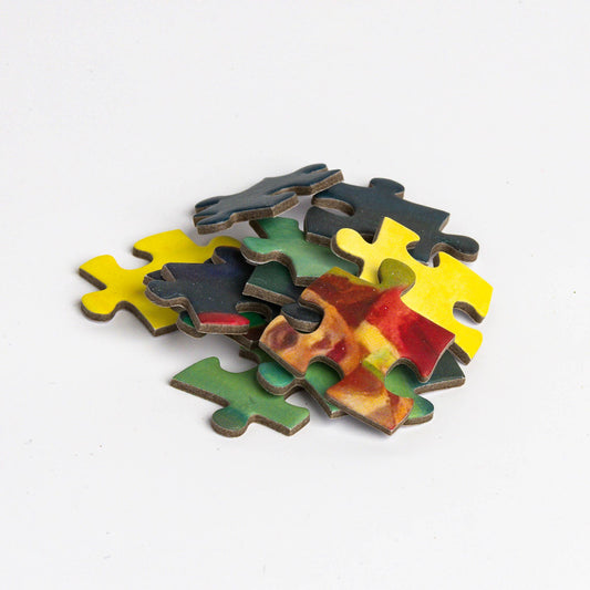 Edward Hopper Nighthawks puzzle pieces in a small pile on a white background.