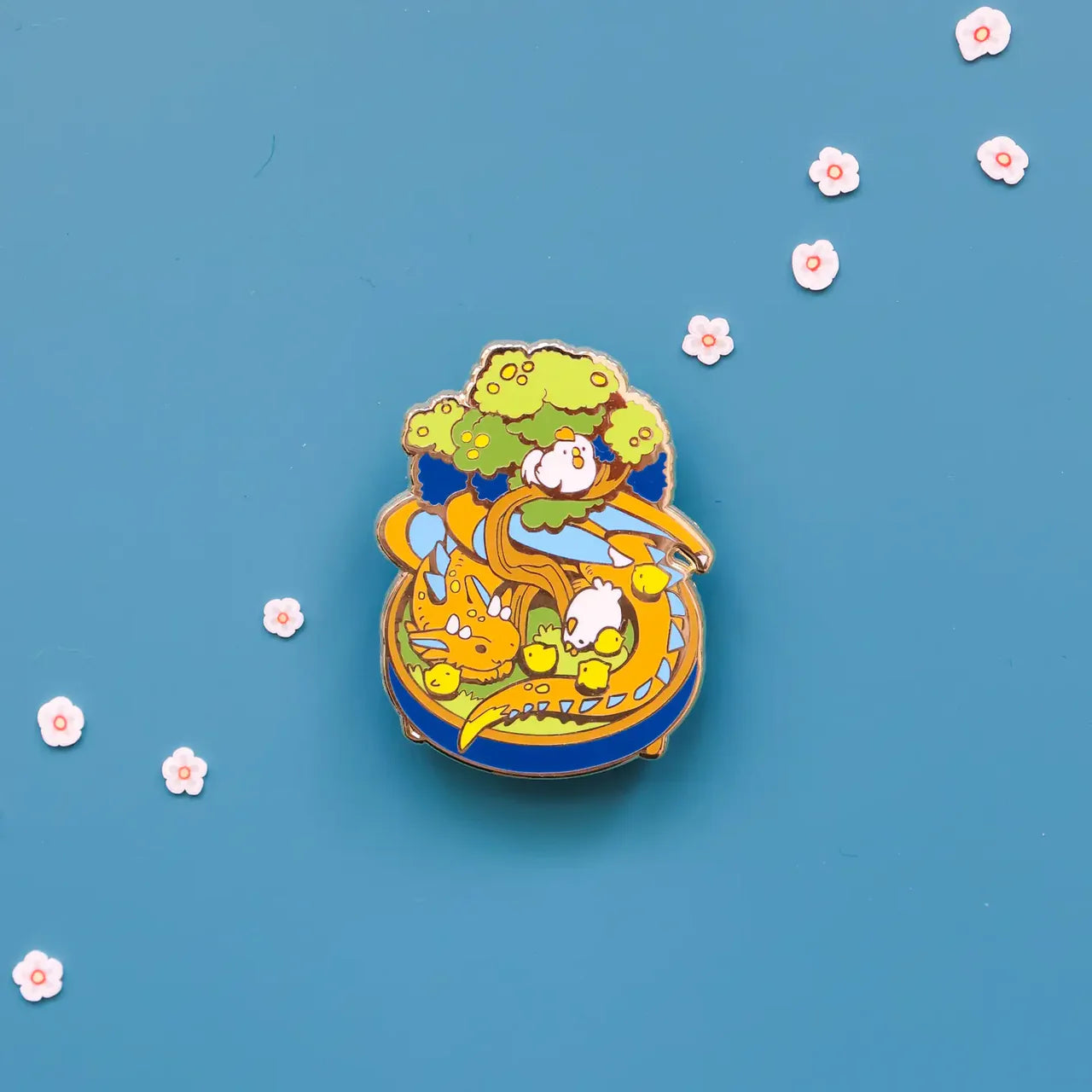 The Bonsai Garden- Dragon Enamel Pin featuring a yellow dragon with baby chicks under a bonsai tree.