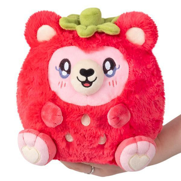 Mini Squishable Strawberry Bear plush with pink fur, green top, and a smiling face.