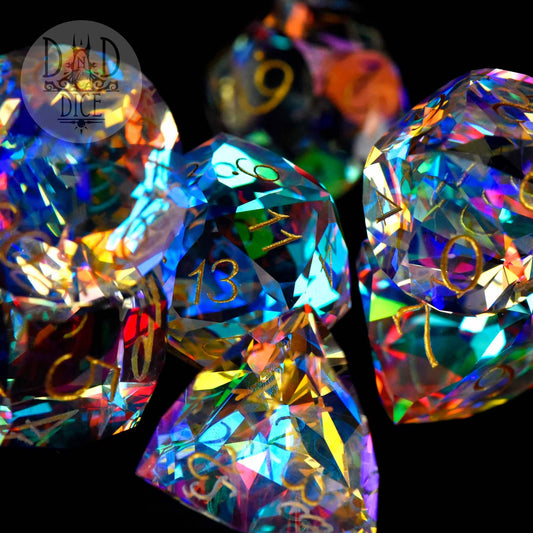 Gem Cut Prism dice set with gold numbers, shown reflecting light; includes gift box.
