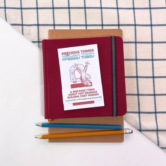 Red Precious Things one-page TTRPG notebook.