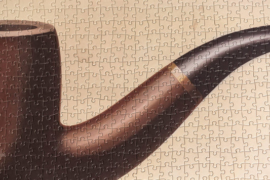 René Magritte This is not a pipe puzzle completed, featuring a brown pipe on a beige background.