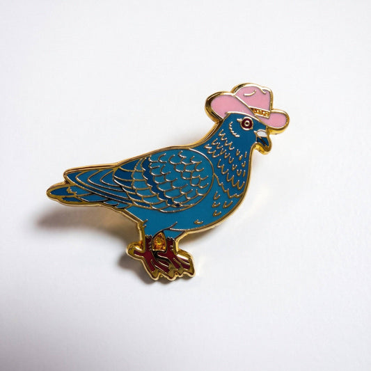 Gold-plated hard enamel pigeon pin wearing a pink cowboy hat with gold trim.