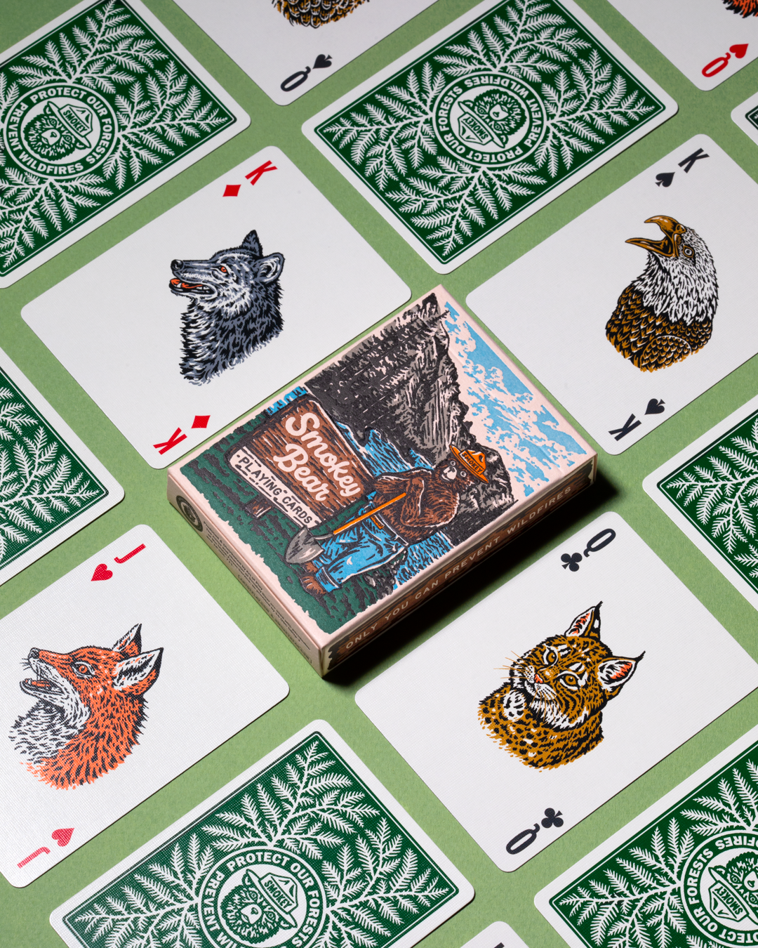 Smokey Bear playing cards with woodland animal illustrations and fire-prevention tips.