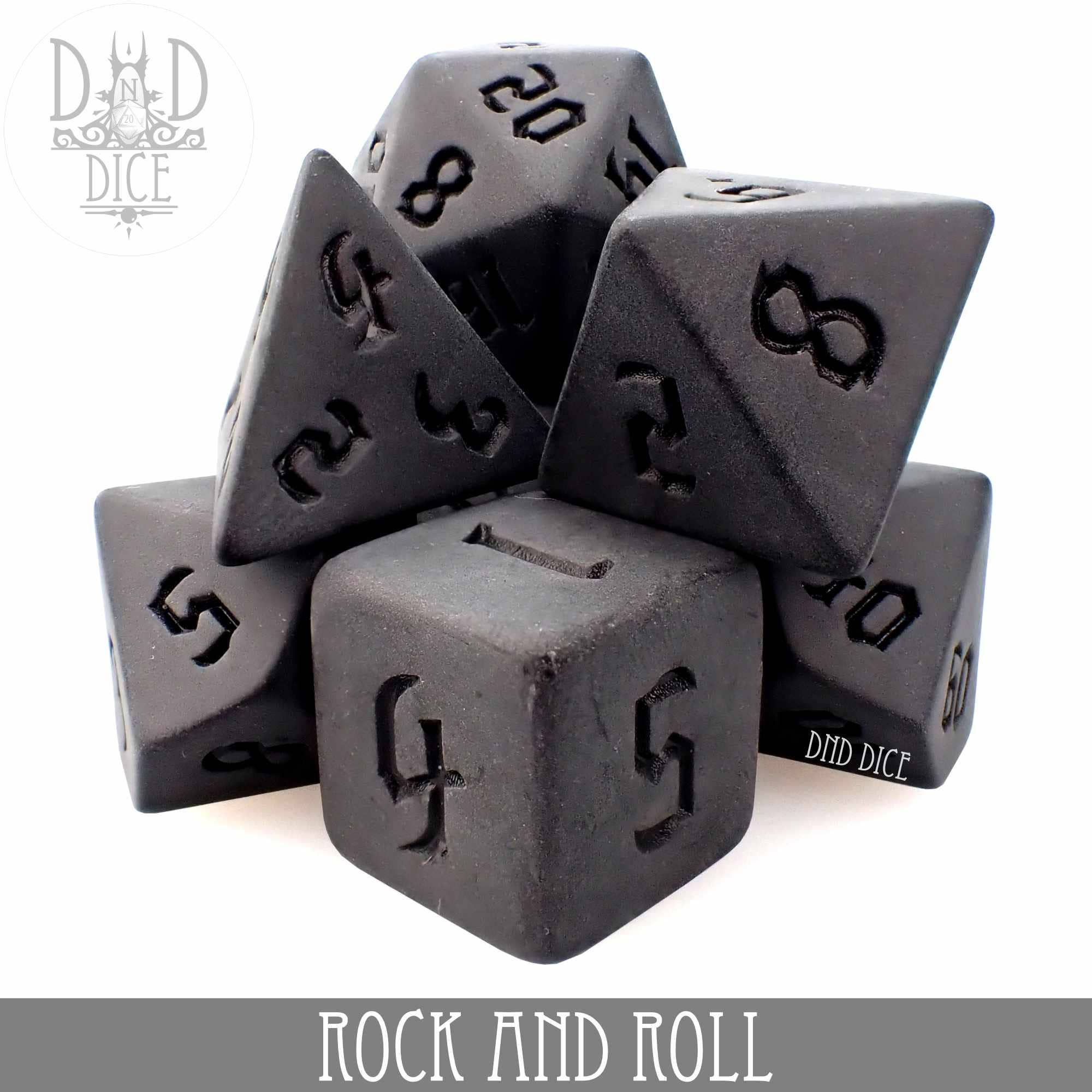Black acrylic tabletop gaming dice set, with Rock and Roll text displayed underneath.
