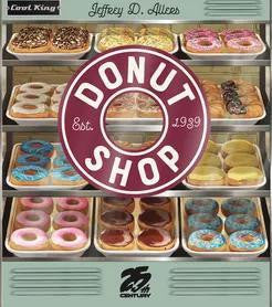 Display case with assorted donuts and shop logo on the glass.