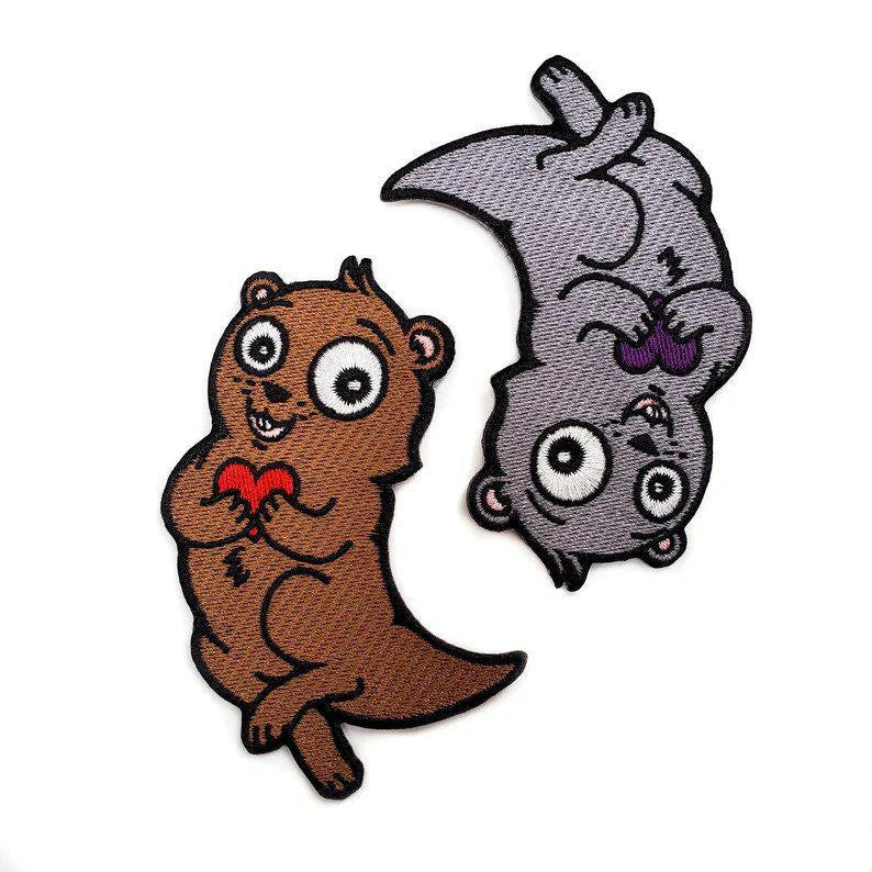 Embroidered Significant Otter Patch by Kolorspun Pins, gray otter holding purple shell, iron-on or sew-on.