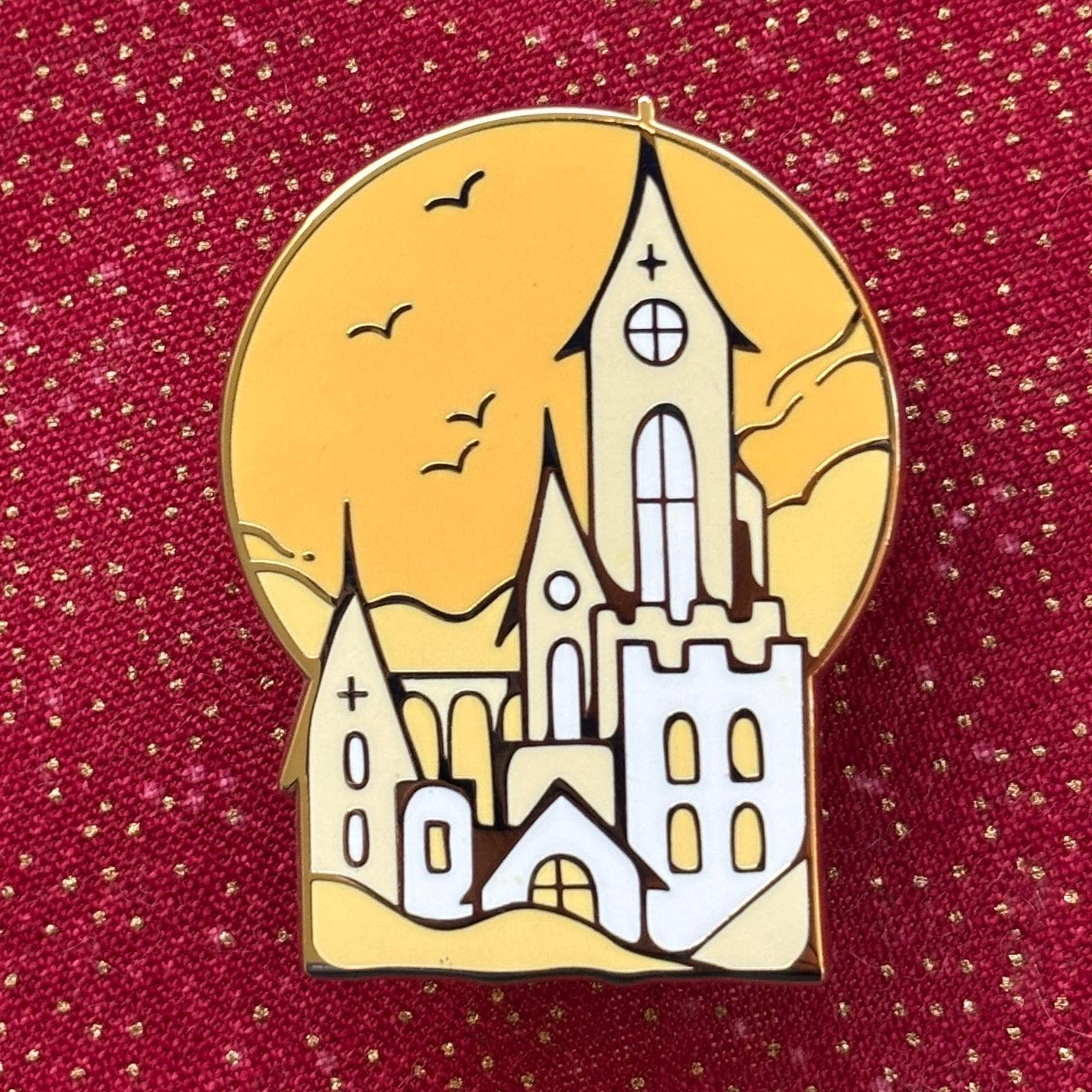 Gothic castle pins with tall spires, orange sky background, red glitter base, and gold plating.