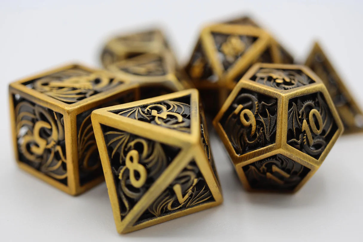 Dragon Essence: Gold - Hollow Metal RPG Dice Set on a white surface.
