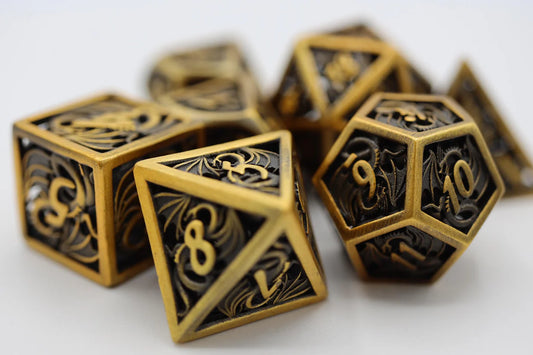 Dragon Essence: Gold - Hollow Metal RPG Dice Set on a white surface.