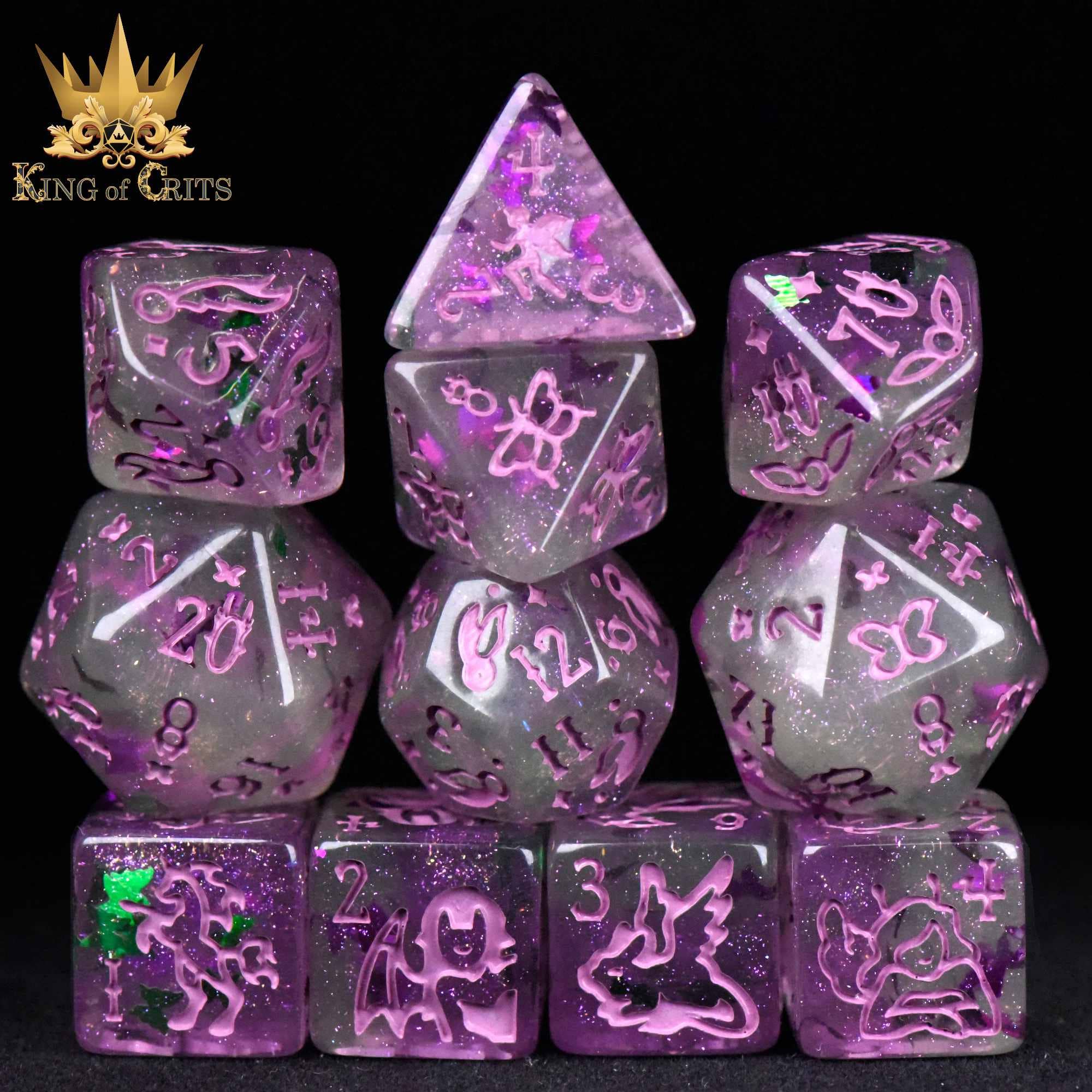 Purple glittery translucent butterfly dice with animal designs, stacked in rows, King of Crits logo in corner.