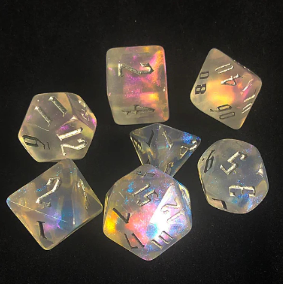 Ice Fae RPG Dice Set with seven iridescent dice featuring black numbers, compatible with Pathfinder and D&D games.