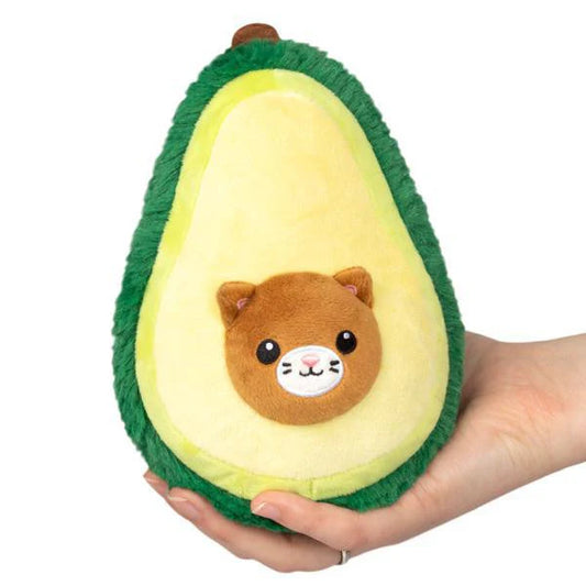 Squishable Alter Egos Avocado-Cat plush toy with cat face pit, shown held in a hand.