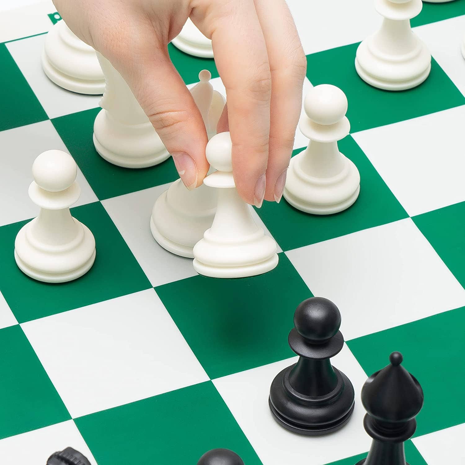 Best Chess Set Ever 3x Tournament Set with weighted pieces and double-sided board, hand moving a white pawn.