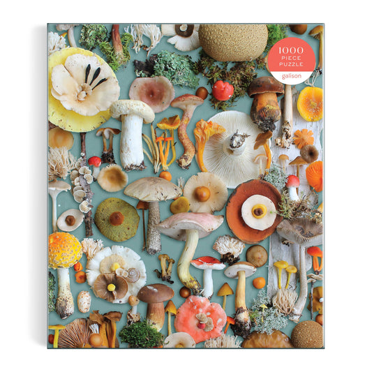 Foraged 1000 Piece Puzzle featuring mushrooms on light blue background, made from recycled paper.
