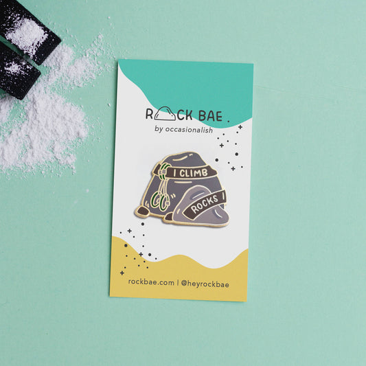I Climb Rocks enamel pin displayed on a Rock Bae card with a mint green and white powder background.