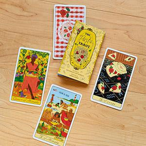 Four Pasta Tarot cards and the yellow box from The Pasta Tarot Deck.