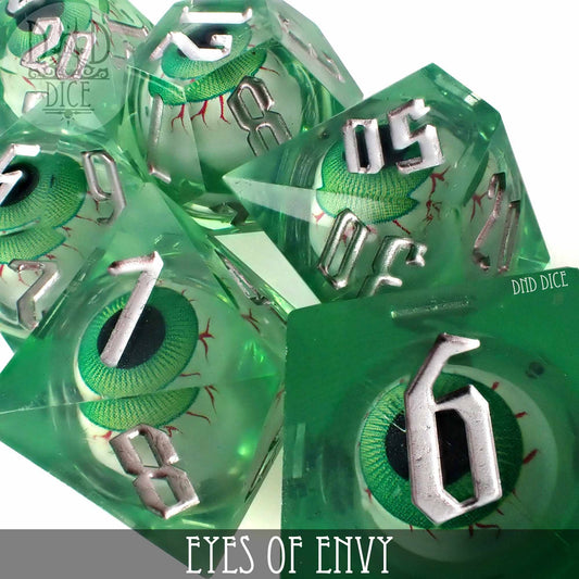 Eyes of Envy - Liquid Core set of 7 green resin dice with embedded green eyes and silver numbers.