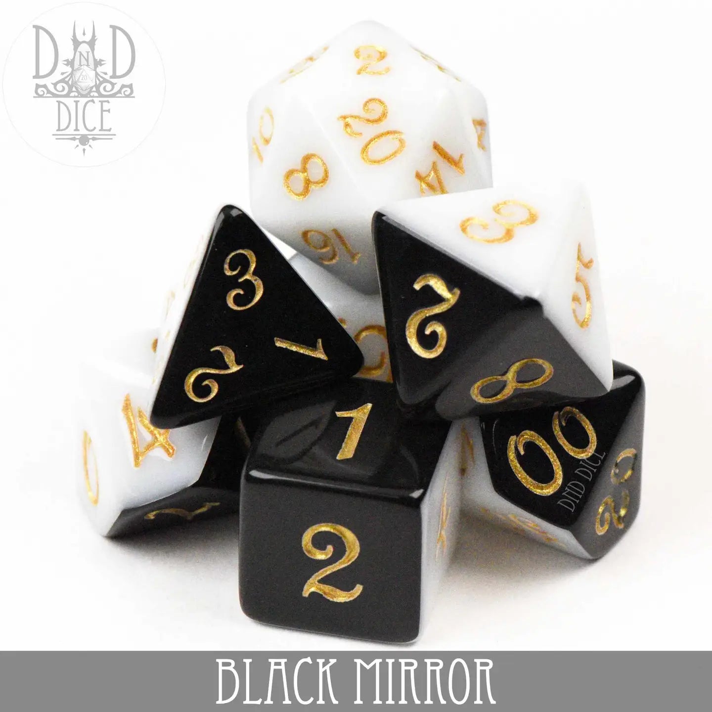 Black Mirror Dice Set with black and white polyhedral dice, gold numbers, and the name on the bottom.