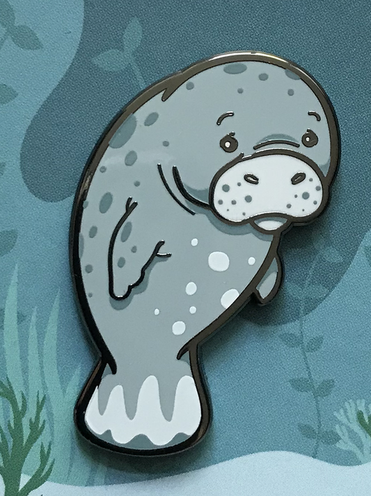 Oh, the Hu-manatee Enamel Pin showing a sad cartoon manatee on a blue background with underwater plants.