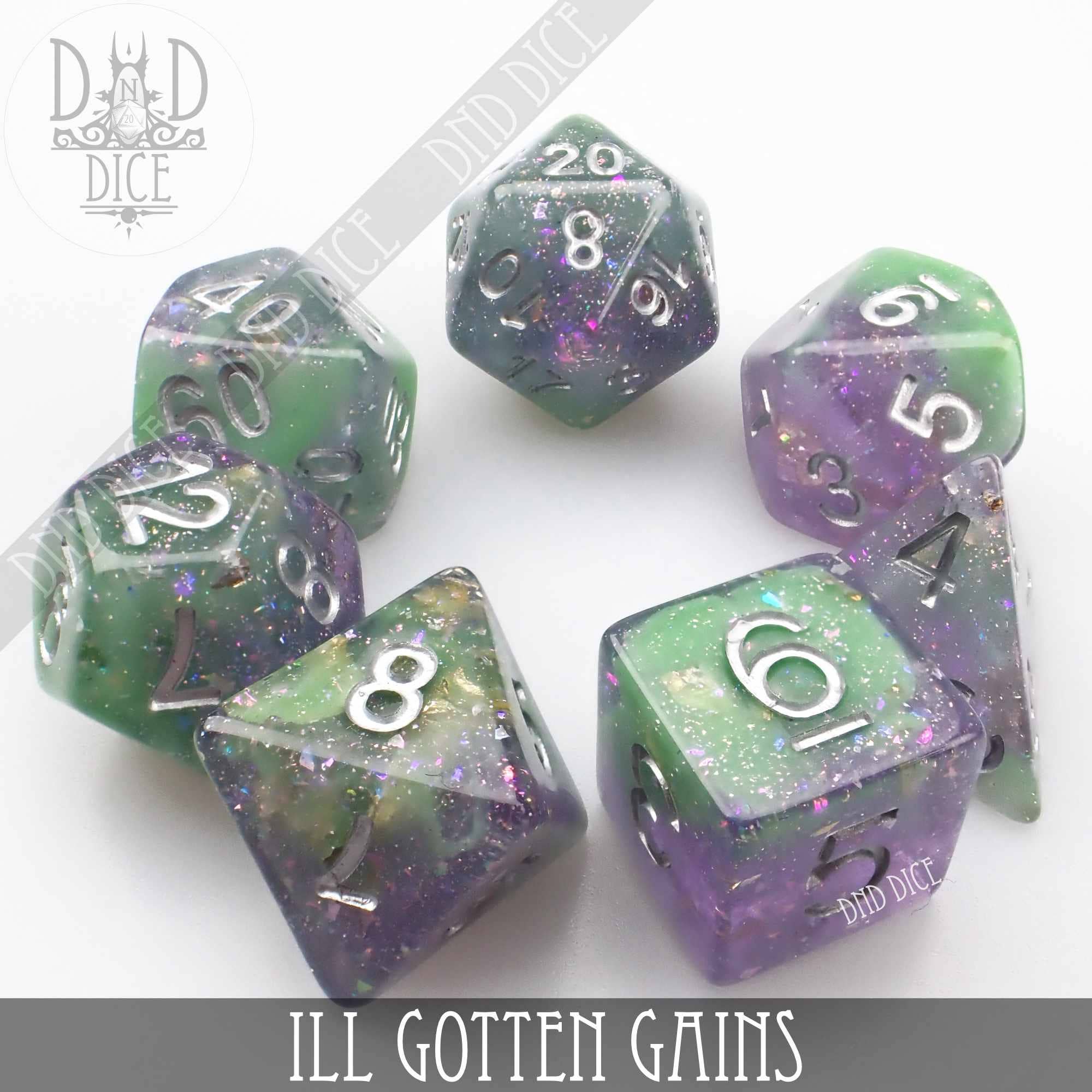 Set of six sparkly green and purple resin dice with silver numbers, labeled Ill Gotten Gains.