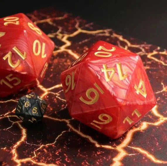 55mm Titan D20 Red Pearl die with gold lightning patterns on a marbled surface.