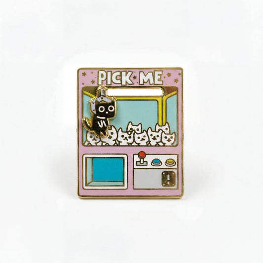 Pick Me Claw Machine Deluxe Pin: gold enamel frame, claw grabbing white cats and one black cat.