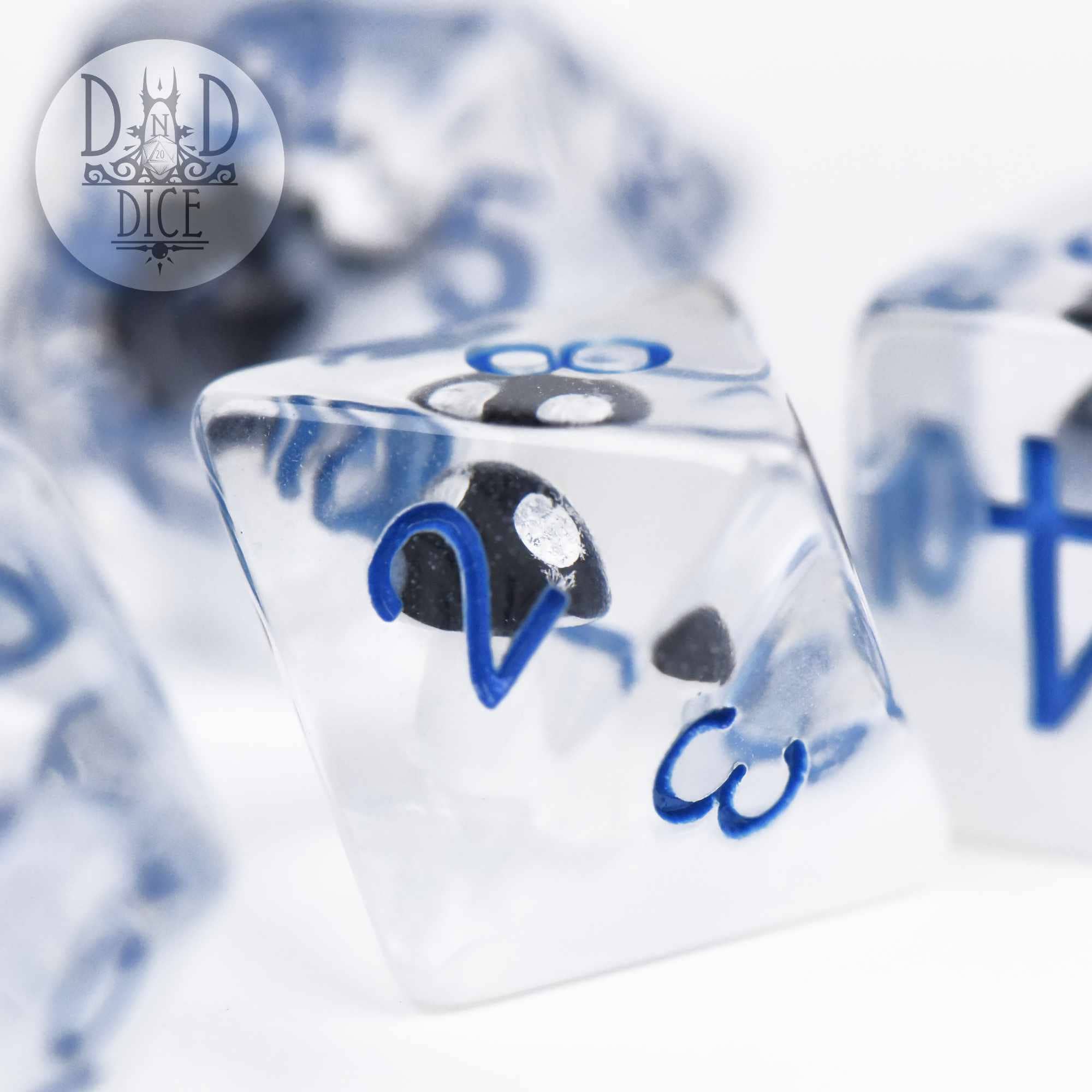 Fungal Freeze clear resin dice with blue numbers and a small black skull inside.