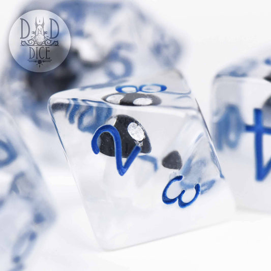 Fungal Freeze clear resin dice with blue numbers and a small black skull inside.