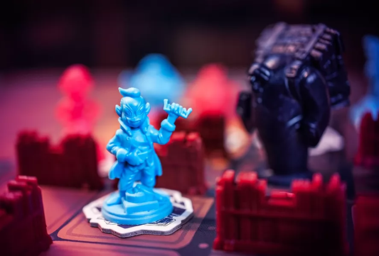 Blue figurine and red pieces on the Mythic Mischief Volume I board game.