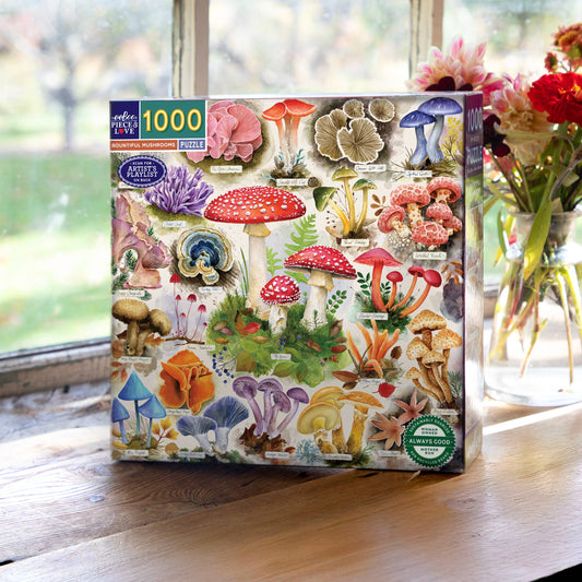 The Bountiful Mushrooms 1000 Piece Puzzle with watercolor art on a wooden table near a window.
