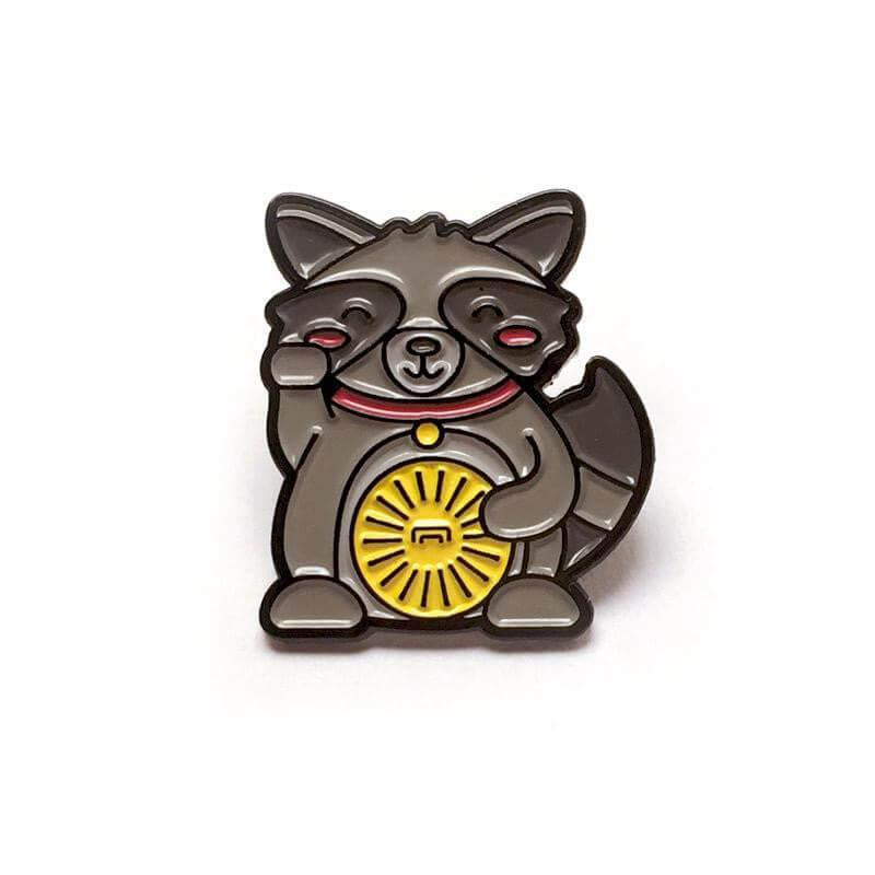 Kolorspun Pins Lucky Raccoon Enamel Pin Standard, featuring a maneki neko-style raccoon holding a yellow coin on white.