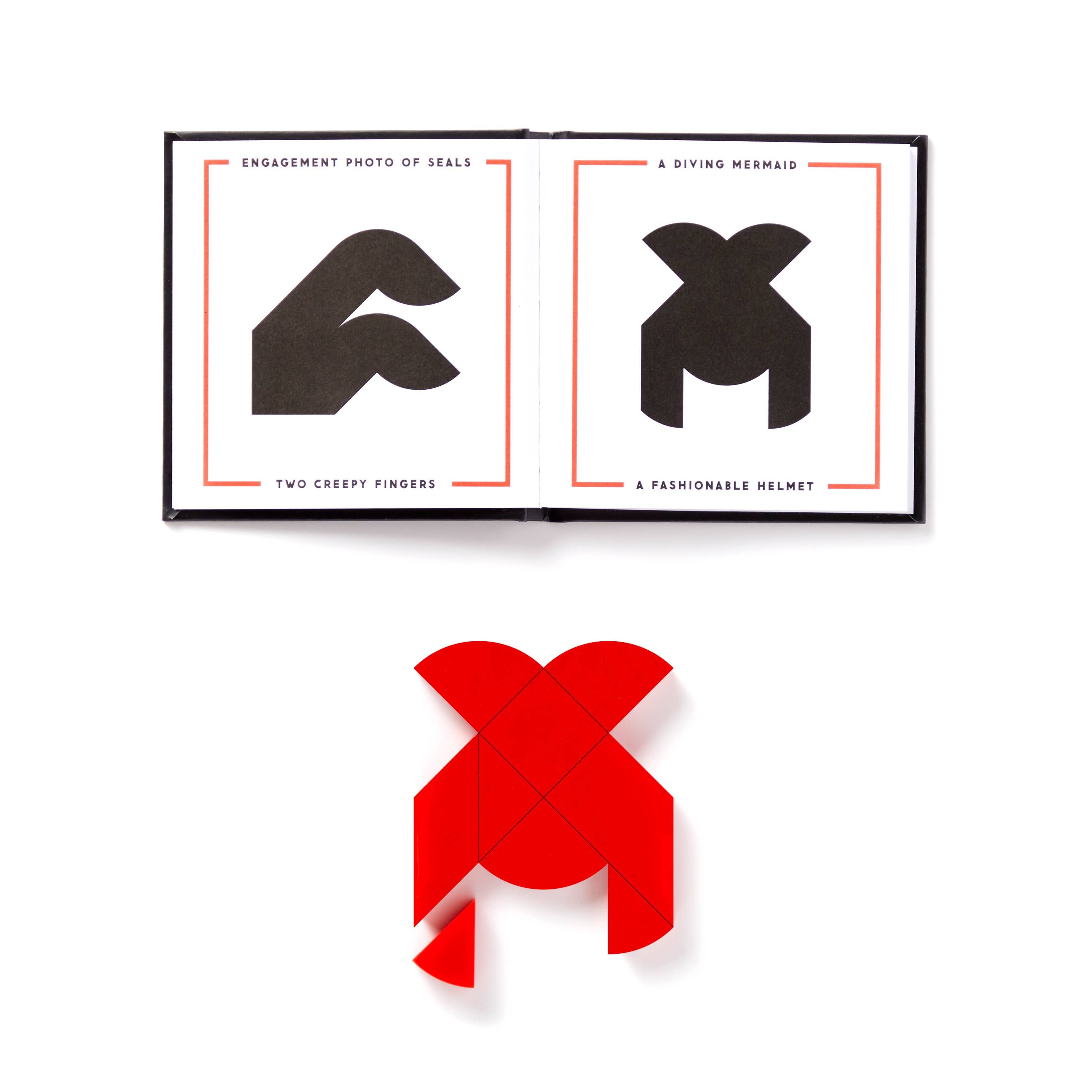 Brass Monkey At First Sight Tangram Puzzle with heart-shaped pieces arranged over an open book as shown in the book.